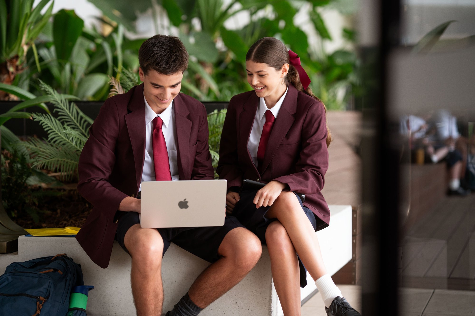 students-using-macbook-outdoors
